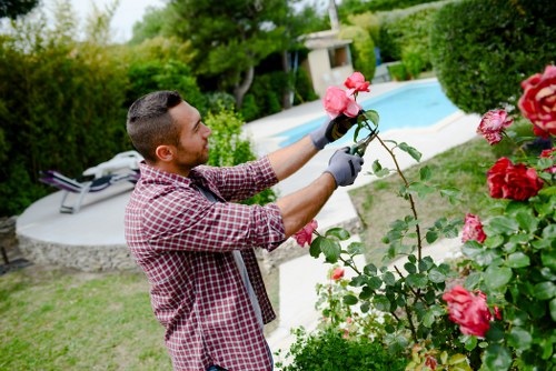 Team member assisting a customer at a garden gate with clear signage